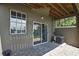 Covered patio with stone flooring and sliding glass doors offer access to outdoor living at 1402 Harbour Walk Rd, Tampa, FL 33602