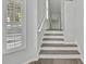 Elegant staircase featuring wood treads, white risers, and a modern handrail at 1402 Harbour Walk Rd, Tampa, FL 33602