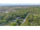 Coastal property featuring lush landscaping and mature trees, overlooking the water at 15025 Shark St, Hudson, FL 34667