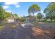 Large backyard featuring a screened pool area, perfect for outdoor entertaining and relaxation at 15025 Shark St, Hudson, FL 34667
