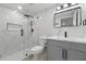 Modern bathroom features marble-style tile, glass shower, and updated fixtures at 15025 Shark St, Hudson, FL 34667
