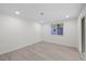 Bedroom area with wood-look floors and a window at 15025 Shark St, Hudson, FL 34667