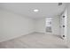 Well lit bedroom with neutral walls, light floors, and an ensuite bathroom at 15025 Shark St, Hudson, FL 34667
