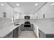 Updated kitchen with stainless steel appliances, quartz countertops, and sleek cabinets at 15025 Shark St, Hudson, FL 34667