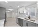 Open kitchen with new stainless steel appliances, stone countertops, and bright white cabinets at 15025 Shark St, Hudson, FL 34667