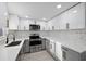 Modern kitchen with stainless steel appliances, quartz countertops, and lots of cabinets at 15025 Shark St, Hudson, FL 34667