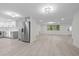 Open-concept living space with laminate floors, modern fixtures, and stainless steel appliances at 15025 Shark St, Hudson, FL 34667