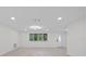 Open living room with wood-look floors and lots of natural light at 15025 Shark St, Hudson, FL 34667