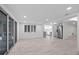 Open-plan living room featuring sliding doors and a view to the kitchen at 15025 Shark St, Hudson, FL 34667