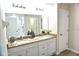 Bathroom with double sinks, granite countertops, and a glass-enclosed shower at 15709 Demory Point Pl, Ruskin, FL 33573