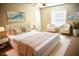 Comfortable bedroom with neutral tones, a king bed, and decorative lamps at 15709 Demory Point Pl, Ruskin, FL 33573