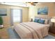 Bright bedroom featuring a king-sized bed and a sunny window at 15709 Demory Point Pl, Ruskin, FL 33573