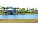 Community clubhouse overlooking a pond with palm trees, lush landscaping and picnic area at 15709 Demory Point Pl, Ruskin, FL 33573