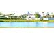 Community playground and splashpad with lush green landscaping and a pond at 15709 Demory Point Pl, Ruskin, FL 33573