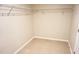 Spacious walk-in closet with neutral paint, metal shelving, and tile flooring, offering ample storage at 15709 Demory Point Pl, Ruskin, FL 33573