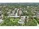 Discover the beauty of this residential area from above, showcasing a community surrounded by mature trees and a beautiful landscape at 1709 Main St, Safety Harbor, FL 34695