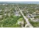 Aerial perspective of this home, surrounded by lush greenery in a serene neighborhood setting at 1709 Main St, Safety Harbor, FL 34695