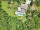 Top-down look at a home with a pool and firepit, perfectly integrated into a sprawling, green landscape at 1709 Main St, Safety Harbor, FL 34695