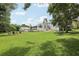 Expansive backyard with fire pit, shed, lush lawn, and mature trees, offering a serene outdoor retreat at 1709 Main St, Safety Harbor, FL 34695
