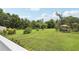 Landscaped backyard with stepping stones, gazebo, and lush greenery, perfect for outdoor activities and relaxation at 1709 Main St, Safety Harbor, FL 34695