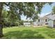 Lush backyard view showcases a pool, shed, and green lawn with mature trees, perfect for outdoor enjoyment at 1709 Main St, Safety Harbor, FL 34695