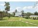 Backyard view features stepping stones, landscaping, shed, and screened patio, ideal for outdoor enjoyment at 1709 Main St, Safety Harbor, FL 34695