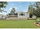 Backyard view with pool, screened in patio, and lush landscaping, perfect for relaxing outdoors at 1709 Main St, Safety Harbor, FL 34695
