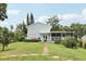 Backyard view features stepping stones, landscaping, shed, and screened patio, ideal for outdoor enjoyment at 1709 Main St, Safety Harbor, FL 34695