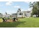 Landscaped backyard view features a fire pit, shed, and ample green space, ideal for entertaining outdoors at 1709 Main St, Safety Harbor, FL 34695