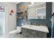 Charming bathroom featuring a gray vanity, octopus decor, and unique decorative wallpaper at 1709 Main St, Safety Harbor, FL 34695