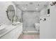 Bathroom featuring double vanity sinks, shower with glass surround and geometric tiled accent wall at 1709 Main St, Safety Harbor, FL 34695