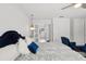 A Primary bedroom with white walls, and a blue upholstered headboard at 1709 Main St, Safety Harbor, FL 34695