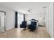 Bright bedroom with hardwood floors, white walls, blue chairs and contemporary decor at 1709 Main St, Safety Harbor, FL 34695