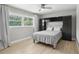 Cozy bedroom featuring natural light, ceiling fan, light wood floors, and built-in shelving at 1709 Main St, Safety Harbor, FL 34695