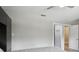 Bedroom with light floors, built-in shelving, and view into en-suite bathroom at 1709 Main St, Safety Harbor, FL 34695
