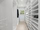 Walk-in closet with custom shelving and ample storage space at 1709 Main St, Safety Harbor, FL 34695