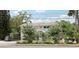 A charming two-story home with attractive landscaping, mature trees, and a view of a well-maintained front yard at 1709 Main St, Safety Harbor, FL 34695