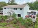 Charming two-story home with manicured landscaping, a screened porch, and an inviting outdoor deck with patio furniture at 1709 Main St, Safety Harbor, FL 34695
