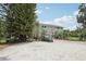 Spacious home with a large gravel driveway, lush landscaping, and ample parking for multiple vehicles at 1709 Main St, Safety Harbor, FL 34695