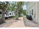 Exterior view of the property showcasing a paved area and convenient side access at 1709 Main St, Safety Harbor, FL 34695