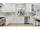 Bright, updated kitchen with marble countertops, stainless appliances, and a view to the living room at 1709 Main St, Safety Harbor, FL 34695
