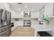 Elegant kitchen featuring stainless steel appliances, marble countertops, and bright, white cabinetry at 1709 Main St, Safety Harbor, FL 34695