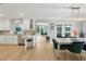 Open kitchen and dining area featuring a breakfast bar, dining table, and access to the outdoors at 1709 Main St, Safety Harbor, FL 34695