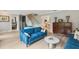 Elegant living room featuring a comfortable blue sofa, hardwood floors, and stylish decor with staircase access at 1709 Main St, Safety Harbor, FL 34695
