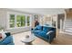 Inviting living room showcasing a plush blue sofa, large windows, and elegant decor with bright hardwood floors at 1709 Main St, Safety Harbor, FL 34695