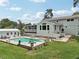 Beautiful backyard featuring a sparkling pool, spa, and outdoor living spaces, perfect for relaxing and entertaining at 1709 Main St, Safety Harbor, FL 34695