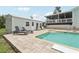 Outdoor pool area with lounge chairs, shed and outdoor furniture, creating a backyard retreat at 1709 Main St, Safety Harbor, FL 34695
