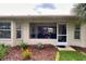 Lush backyard with a palm tree, well-maintained lawn, and a charming brick-lined flower bed at 18531 Bent Pine Dr, Hudson, FL 34667