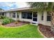 Lush backyard with a palm tree, well-maintained lawn, and a charming brick-lined flower bed at 18531 Bent Pine Dr, Hudson, FL 34667