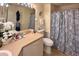 Cozy bathroom featuring seashell themed shower curtain and neutral-toned vanity at 18531 Bent Pine Dr, Hudson, FL 34667